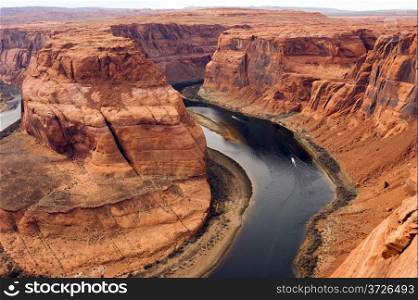 Boats carry travelers far below the ridge in the Colorado River