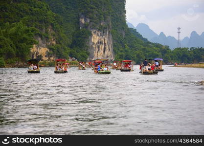 Boats in a river with a hill range in the background, Guilin Hills, XingPing, Yangshuo, Guangxi Province, China