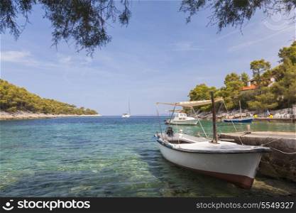 Boats in a tranquil coast lagoon at a beach on Hvar Island, Croatia