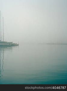 Boats in harbour in fog