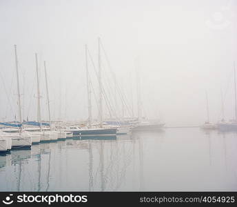 Boats in harbour in fog