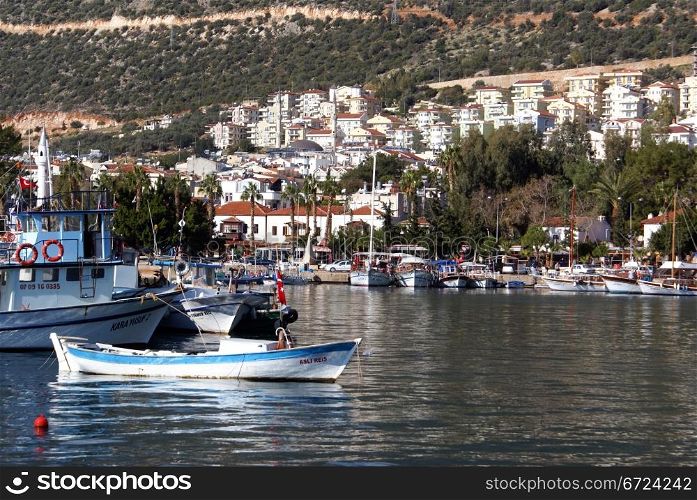 Boats in marina and houses in Kash, Turkey