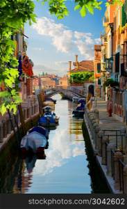 Boats in narrow venetian water canal, Italy. Venetian canal Italy