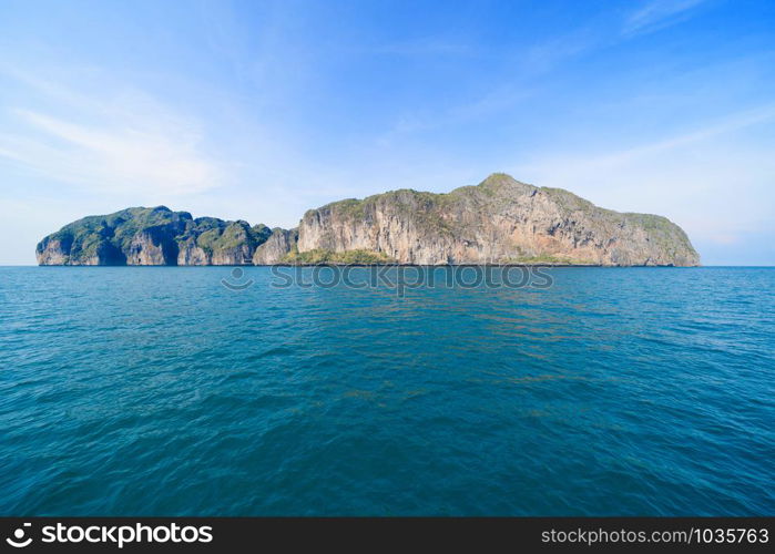 Boats in Patong beach with blue turquoise seawater, Phuket island in summer season during travel holidays vacation trip. Andaman ocean, Thailand. Tourist attraction with blue cloud sky.