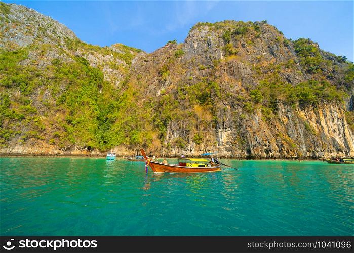 Boats in Phi Phi, Maya beach with blue turquoise seawater, Phuket island in summer season in travel holiday vacation trip. Andaman ocean, Thailand. Tourist attraction with blue sky. Nature landscape.
