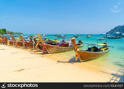 Boats in Phi Phi, Maya beach with blue turquoise seawater, Phuket island in summer season in travel holiday vacation trip. Andaman ocean, Thailand. Tourist attraction with blue sky. Nature landscape.