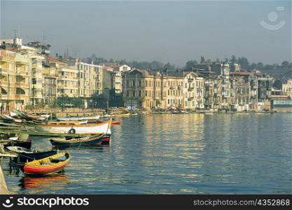 Boats moored at a harbor with buildings at the waterfront, Istanbul, Turkey
