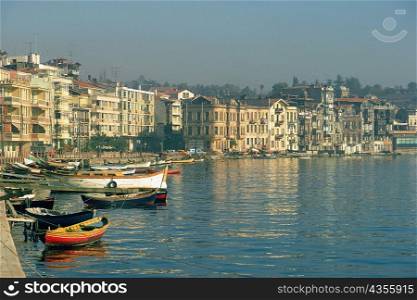 Boats moored at a harbor with buildings in the waterfront, Istanbul, Turkey