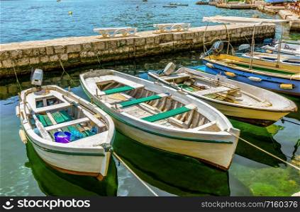 Boats moored in calm harbor of Perast, Montenegro. Moored boats in Perast