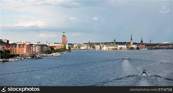 Boats moving in the bay with buildings in the background, Stockholm Town Hall, Riddarfjarden, Stockholm, Sweden