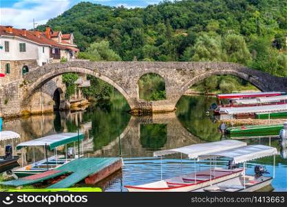 Boats near Old bridge on Crnojevica river in Montenegro. Crnojevica river bridge