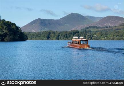 Boats on edge of Derwentwater in English Lake District in early morning