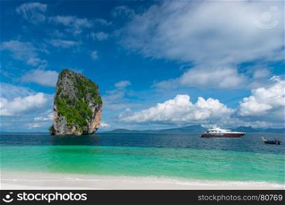 boats, sea, clouds and a beautiful cliff face view from the island of Poda, Thailand