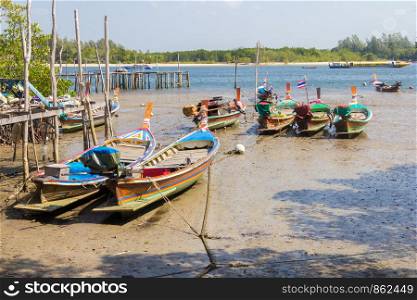 Boats tied up in the mud at Saladan, Koh Lanta, Krabi, Thailand
