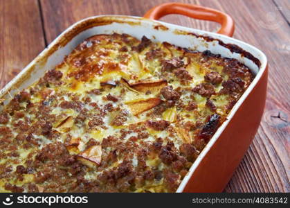 Bobotie also spelt bobotjie, is a South African dish consisting of spiced minced meat baked with an egg-based topping