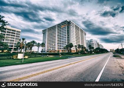 Boca Raton at sunset, Florida. Road,trees and buildings.