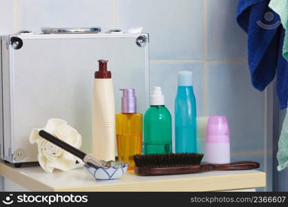 Body and skin care,hygiene concept - bottles with liquid soap or lotion cosmetics set in bathroom. Toiletries in bathroom on shelf