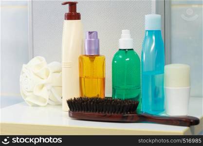 Body and skin care,hygiene concept - bottles with liquid soap or lotion cosmetics set in bathroom. Toiletries in bathroom on shelf