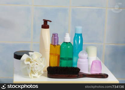 Body and skin care,hygiene concept - bottles with liquid soap or lotion cosmetics set in bathroom. Toiletries in bathroom on shelf