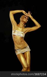 Body Art. Coloring. Graceful Woman with Shiny Gold Makeup in Reverie. Golden Statue