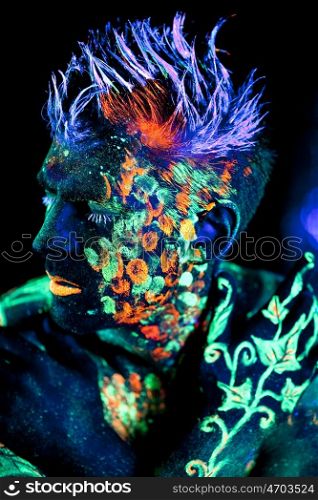 Body art glowing in ultraviolet light
