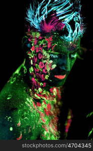 Body art glowing in ultraviolet light