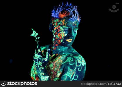 Body art glowing in ultraviolet light