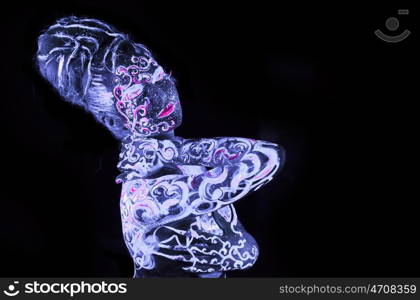 Body art glowing in ultraviolet light