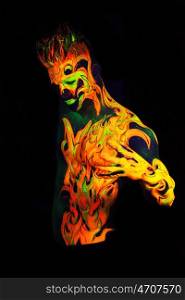 Body art glowing in ultraviolet light - Fire