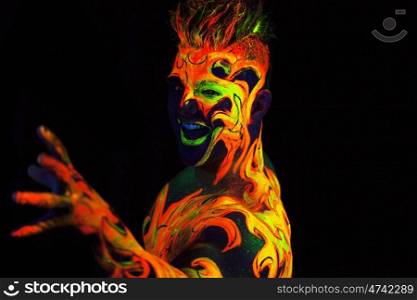 Body art glowing in ultraviolet light - Fire