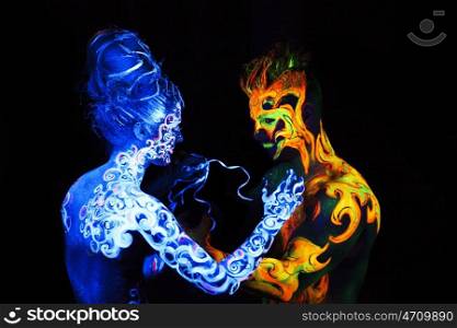 Body art glowing in ultraviolet light, four elements, Air against Fire