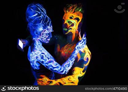 Body art glowing in ultraviolet light, four elements, Air against Fire