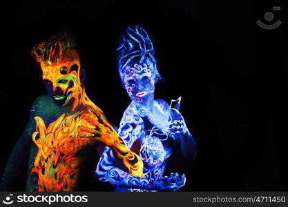 Body art glowing in ultraviolet light, four elements, Air against Fire