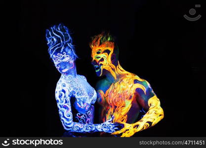 Body art glowing in ultraviolet light, four elements, Air against Fire