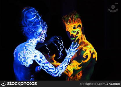 Body art glowing in ultraviolet light, four elements, Air against Fire