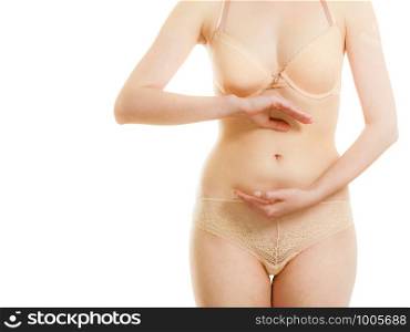 Body care and pregnancy. Part body woman creating sign symbol on her belly. Female hands on smoothy stomache.. Female hands forming shape on belly.
