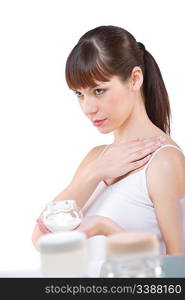 Body care: Beautiful woman applying cream on white background