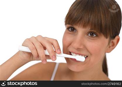 Body care - Female teenager brushing teeth with white toothbrush