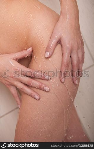 Body care: Naked woman having shower in bathroom