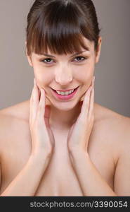 Body care: Portrait of beautiful woman on gray background