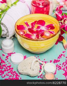 Body care setting with sponge,creme, towel , water bowl with flowers. Spa and wellness concept.