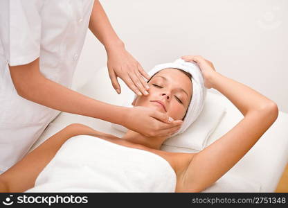 Body care - woman at face massage in spa center