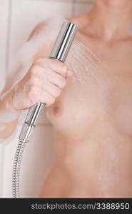 Body care: Woman holding shower head