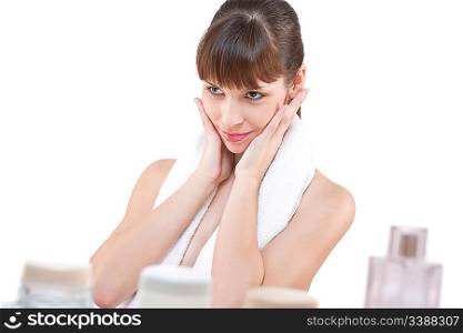 Body care: Young woman applying cream in bathroom on white background