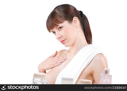 Body care: Young woman applying lotion in bathroom, isolated on white