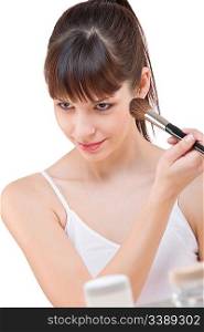 Body care: Young woman applying powder with make-up brush on white background