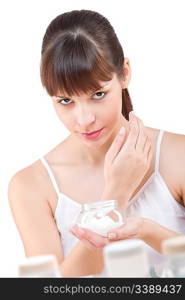 Body care: Young woman with jar of moisturizer in bathroom, on white background