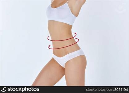 Body correction with the help of plastic surgery on white background, side view. Woman belly marked out for cosmetic surgery or liposuction