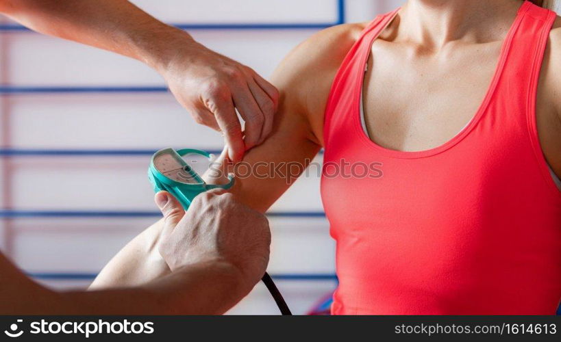 Body fat skinfold test for adults, using caliper on an upper arm, over biceps muscle