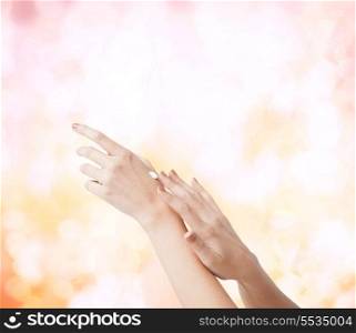 body parts, cosmetics and spa concept - close up of female soft skin hands with creme
